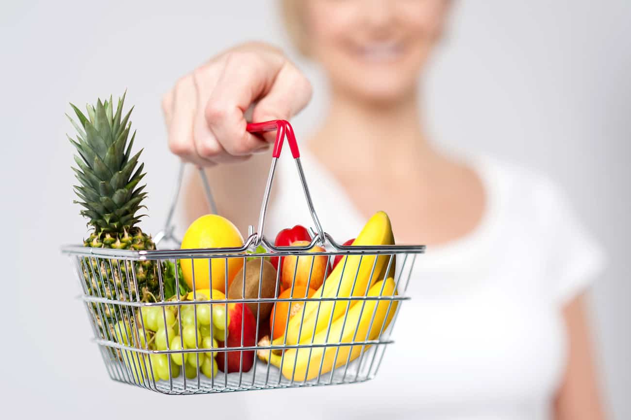 Cropped image of woman showing shopping cart